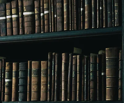Shelves of old leather-bound books